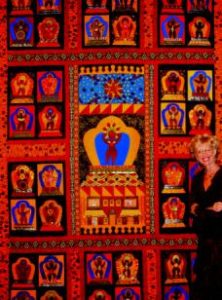 Photo of Beth Mount in front of graphic quilt