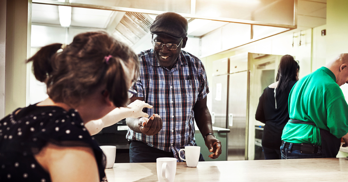 A woman receives change at a restaurant counter
